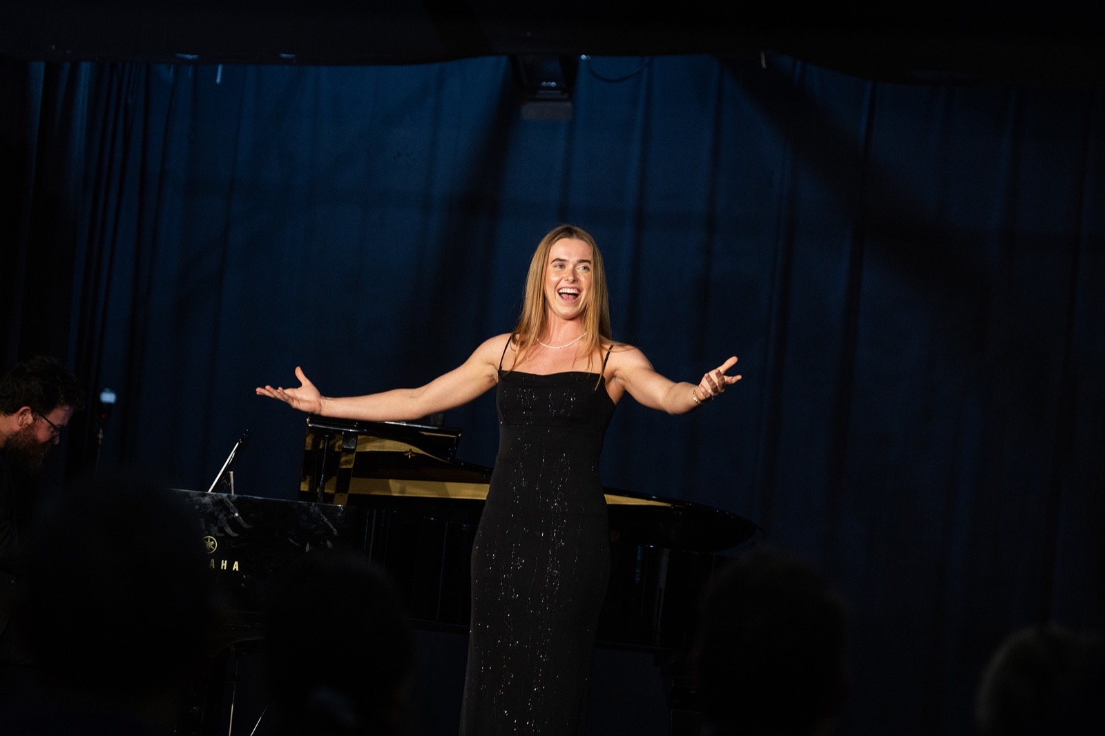 A soprano greets the audience with open arms after her performance at the North of Perth Music Festival.
